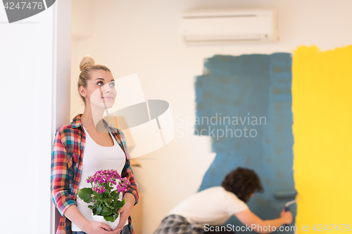 Image of happy young couple doing home renovations