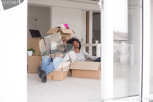 Image of African American couple  playing with packing material