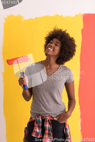 Image of black woman painting wall