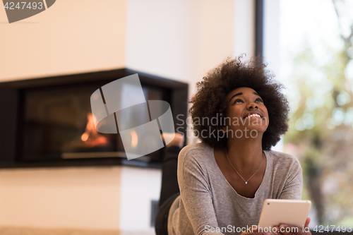 Image of black women using tablet computer on the floor