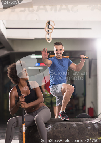 Image of multiethnic couple after workout with hammer