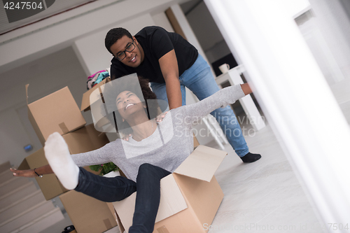 Image of African American couple  playing with packing material