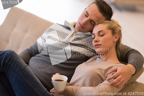 Image of Young couple  in front of fireplace