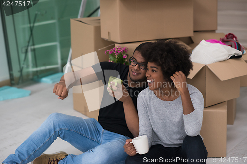 Image of African American couple relaxing in new house