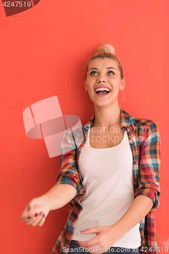 Image of woman over color background plays with apple