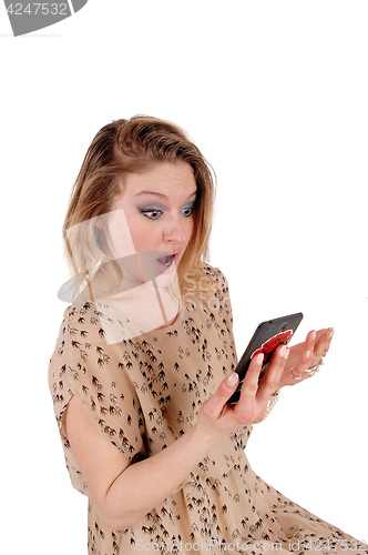 Image of Surprised woman looking at her cellphone.