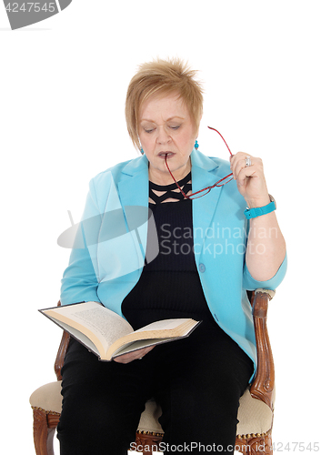 Image of Senior woman reading book.