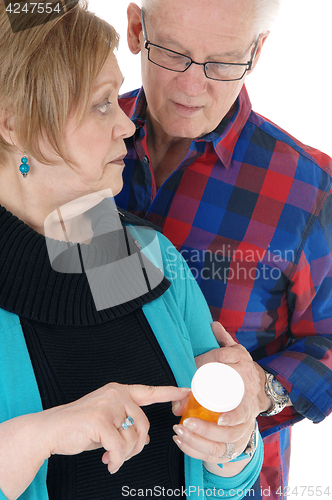 Image of Wife showing husband his pills.