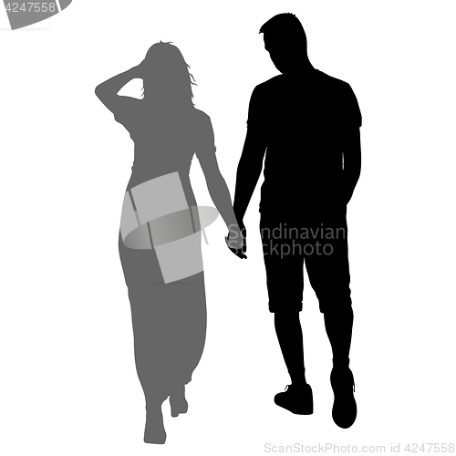 Image of Silhouette man and woman walking hand in hand