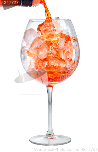 Image of red aperitif pouring into glass