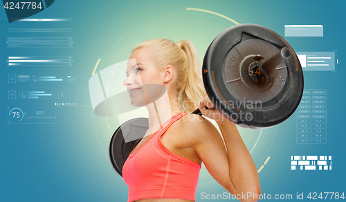Image of sporty young woman flexing muscles with barbell