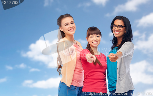 Image of international happy women pointing finger at you