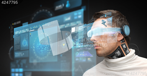 Image of man in virtual reality glasses and microchip