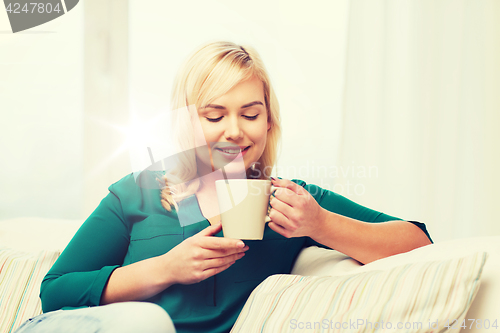 Image of happy young woman at home