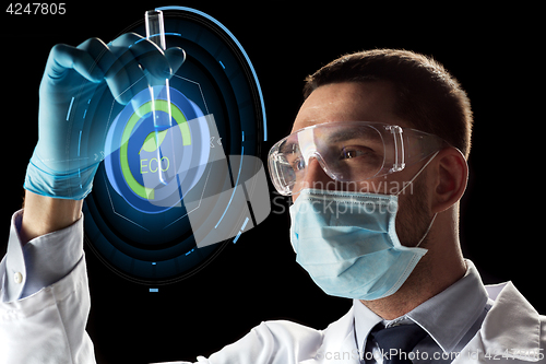 Image of scientist with test tube and virtual projection