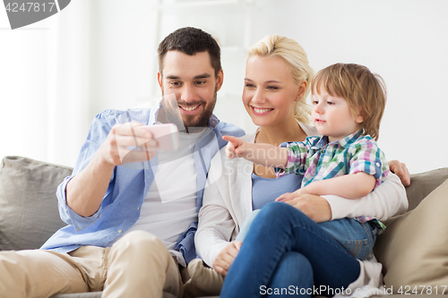 Image of happy family with smartphone at home