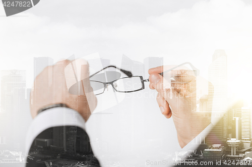 Image of close up of businessman hands holding glasses