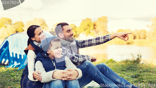 Image of happy family with tent at camp site