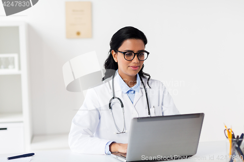 Image of female doctor with laptop at hospital