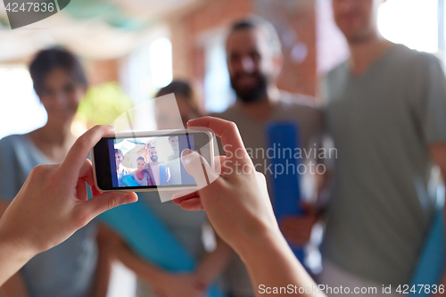 Image of photo of people at yoga studio on smartphone