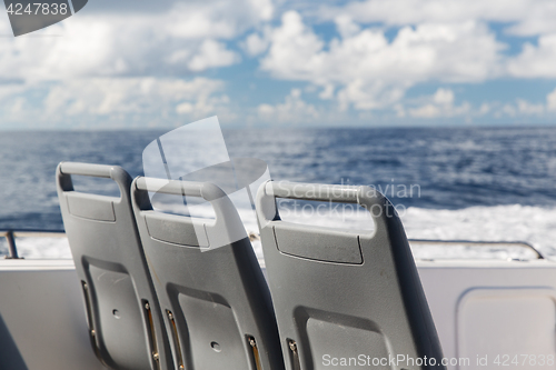 Image of seats on deck of passenger ship sailing in sea