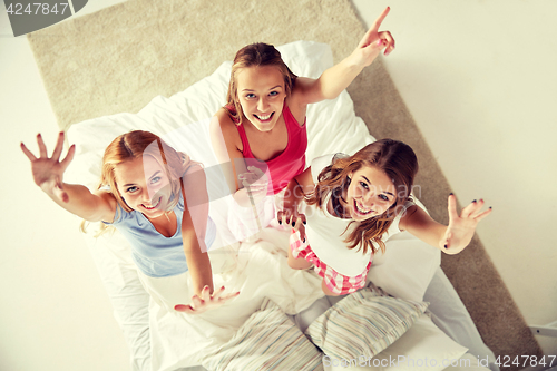 Image of happy friends or teen girls having fun at home