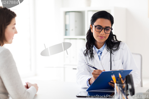 Image of doctor with clipboard and woman at hospital