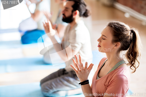 Image of group of people meditating at yoga studio