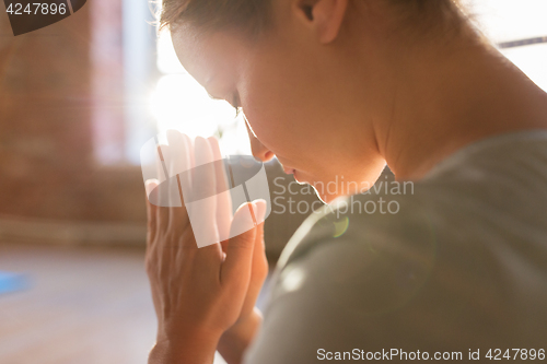 Image of close up of woman meditating at yoga studio