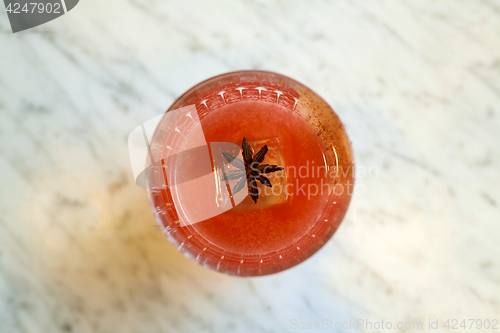 Image of glass of cocktail with anise at bar