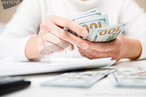 Image of Hands counting money, close up