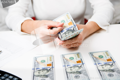 Image of Hands counting money, close up