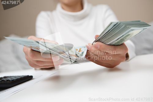 Image of Hands counting money, close up