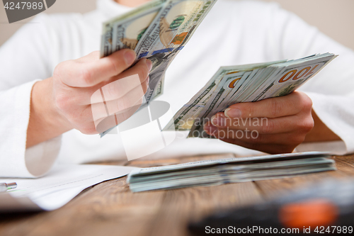 Image of Hands counting money, close up