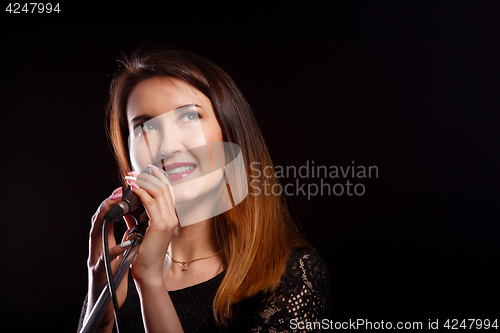 Image of Singing girl on black background