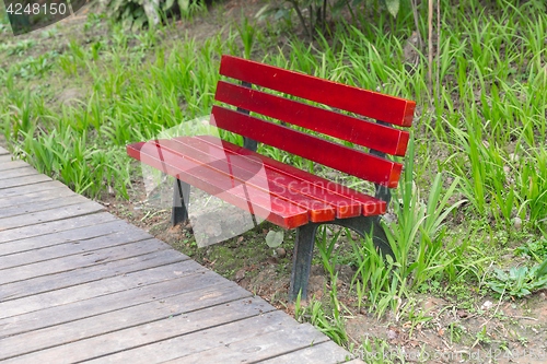 Image of Red bench in the park outdoors