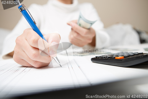 Image of Entrepreneur calculating and reviewing investment plan