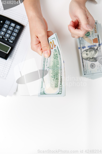 Image of Hands counting money, close up