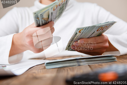 Image of Hands counting money, close up