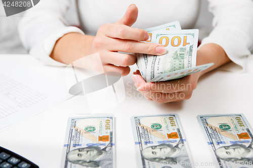 Image of Hands counting money, close up