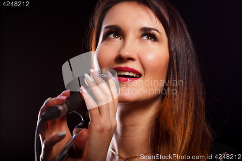 Image of Singing woman on black background