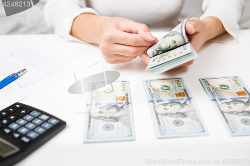 Image of Hands counting money, close up