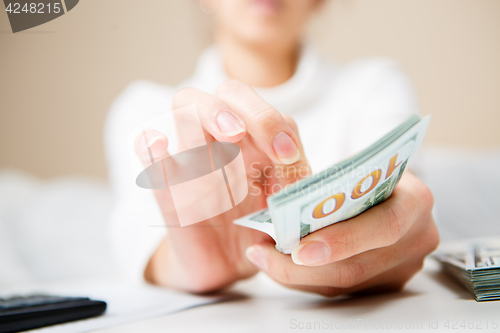 Image of Hands counting money, close up