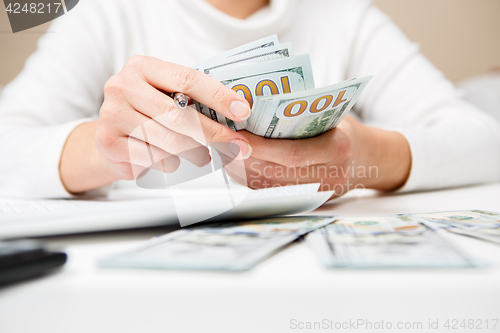 Image of Hands counting money, close up