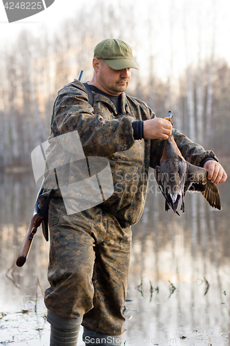 Image of hunter holding a duck