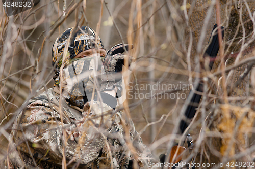 Image of hidden hunter in shrubs