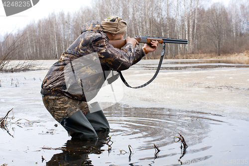 Image of hunter shooting from a gun