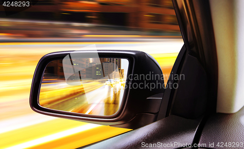 Image of rear-view of moving car at night