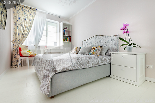 Image of elegant bedroom in soft light colors