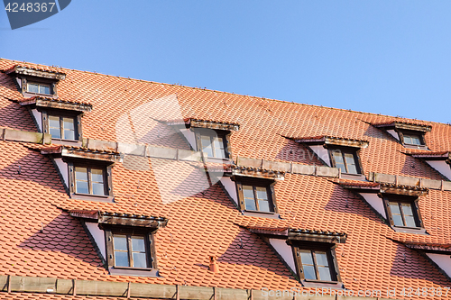 Image of Tiled roof with mansard windows of attic rooms